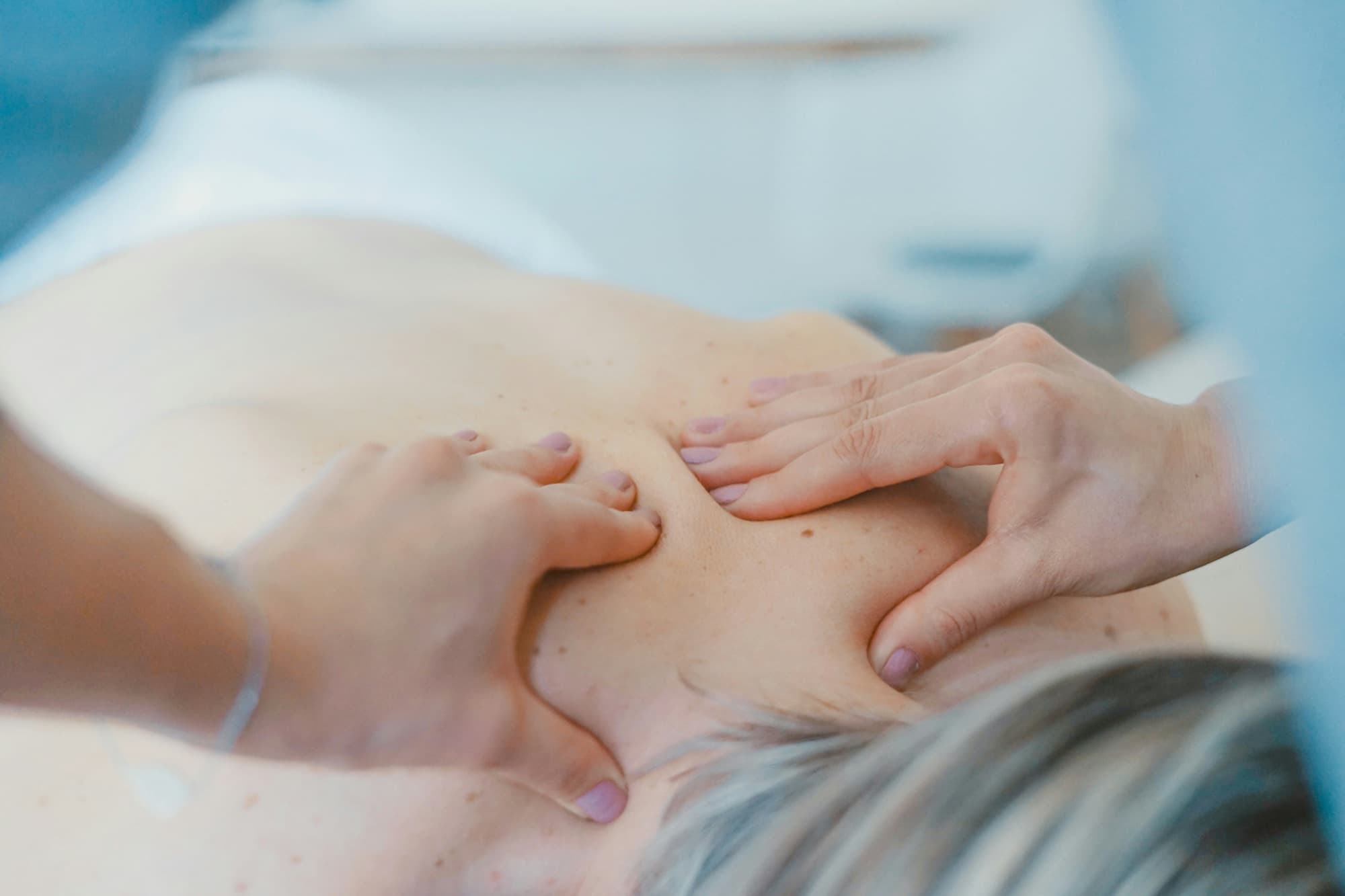 Therapist massaging a client's back
